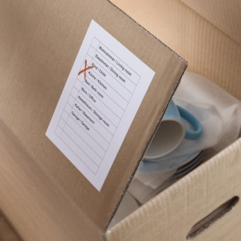 white HERMA label on a moving box