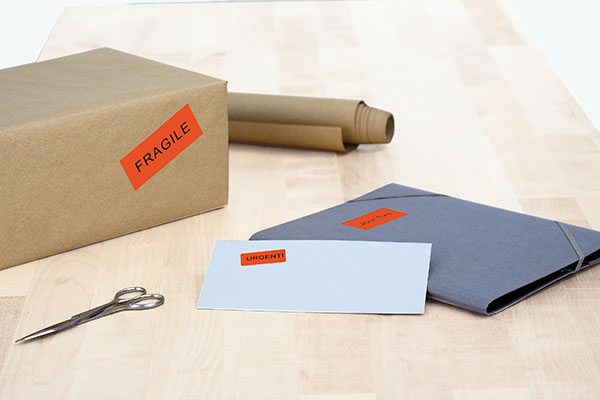 Red labels indicating on envelopes and packages