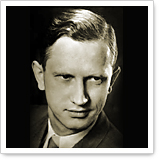 Black-and-white portrait of a man with short, smooth hair and a suit, looking directly at the camera.