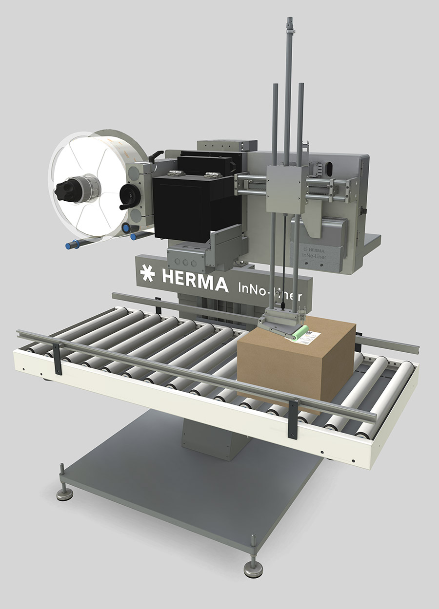 Automatic labeling system from HERMA with a conveyor belt and a box being labeled.