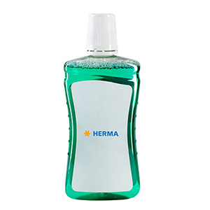 Green liquid in a transparent bottle with a white label that reads 'HERMA'.