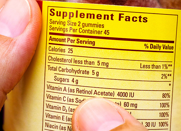 Nutritional information on a supplement packaging, including calories, cholesterol, carbohydrates, and vitamins.