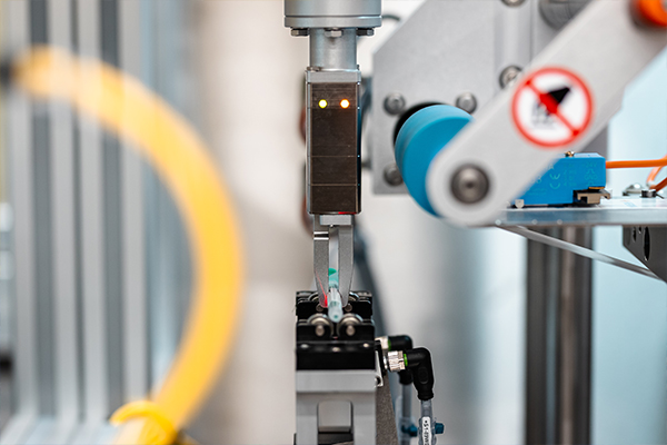 An automated robotic arm with a gripper that performs precise movements to grasp an object.