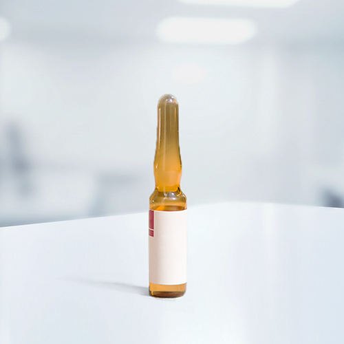 Brown glass vial with a white label, placed on a white table in a bright room.