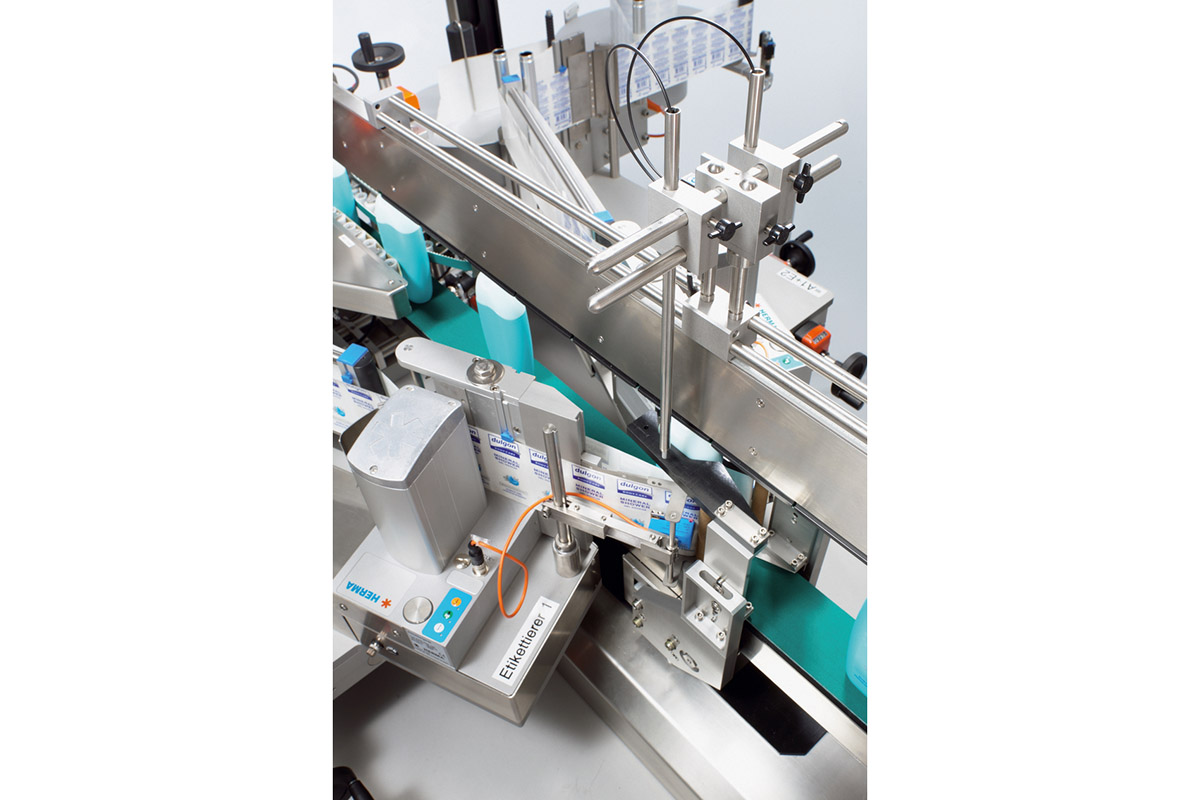An industrial labeling machine with multiple components for applying labels to products.