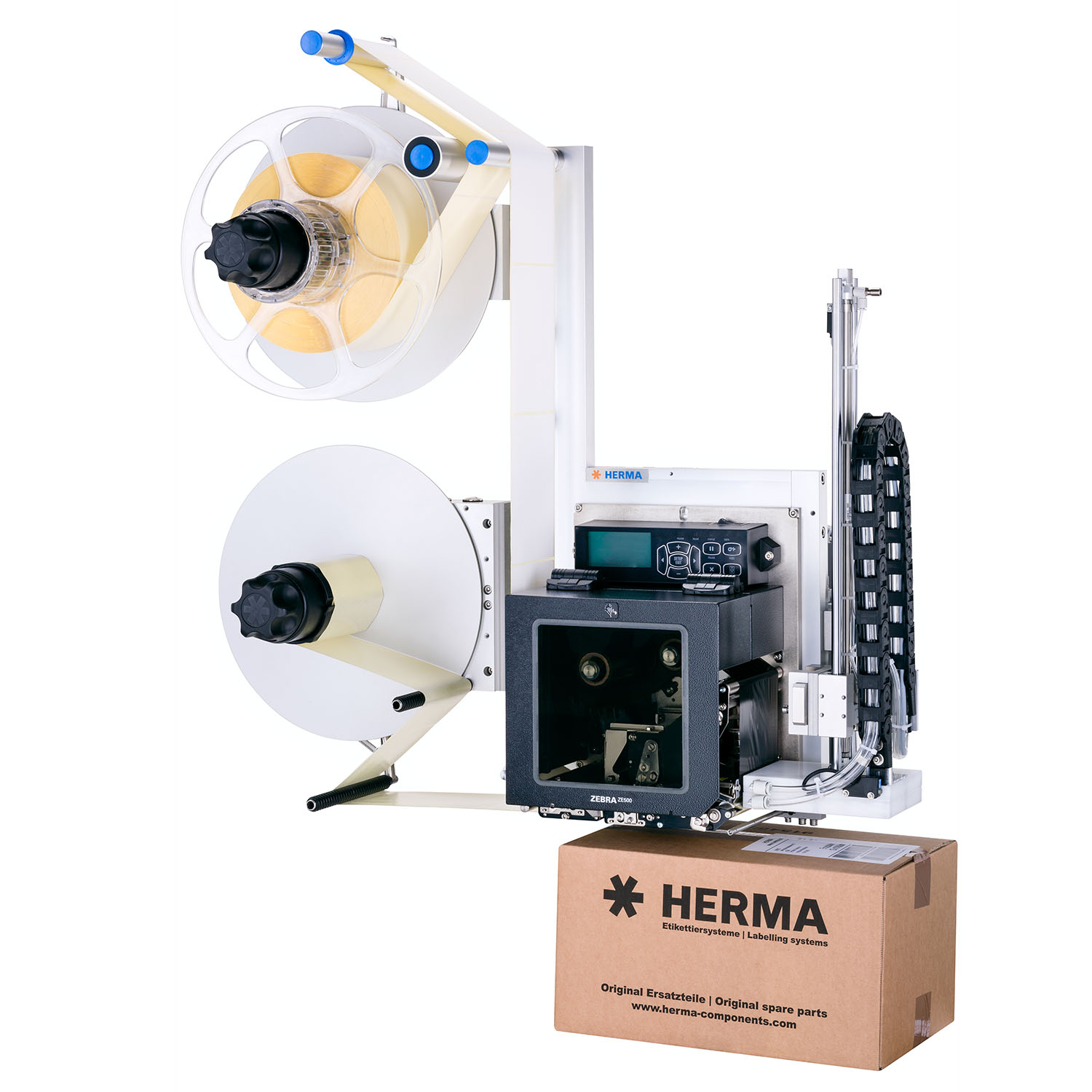Labeling machine with two rolls, a printer, and a cardboard packaging featuring the HERMA logo.