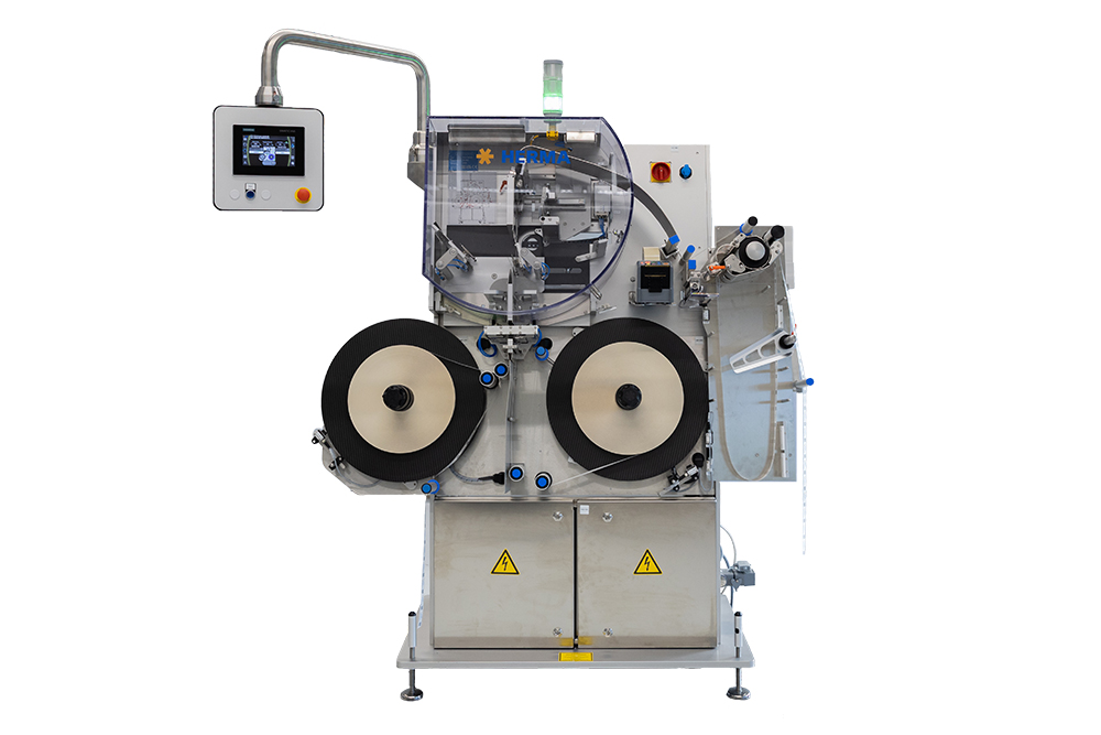 An industrial machine with two large rollers, a control panel, and various control elements for processing materials.