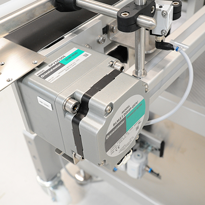 An electric motor with a conveyor belt mounted on an industrial machine for automating production processes.