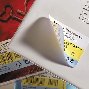 Removable book label on a book spine, one corner has come loose.
