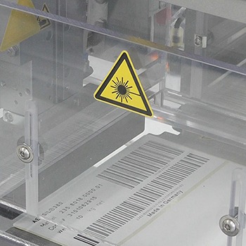 Laser-activatable labels with barcode in the production process, close-up of the CO2 laser printing unit.