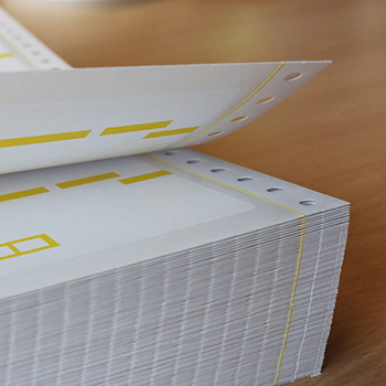 Blank labels: Stack of HERMA folded labels, also known as computer labels or perforated edge labels.