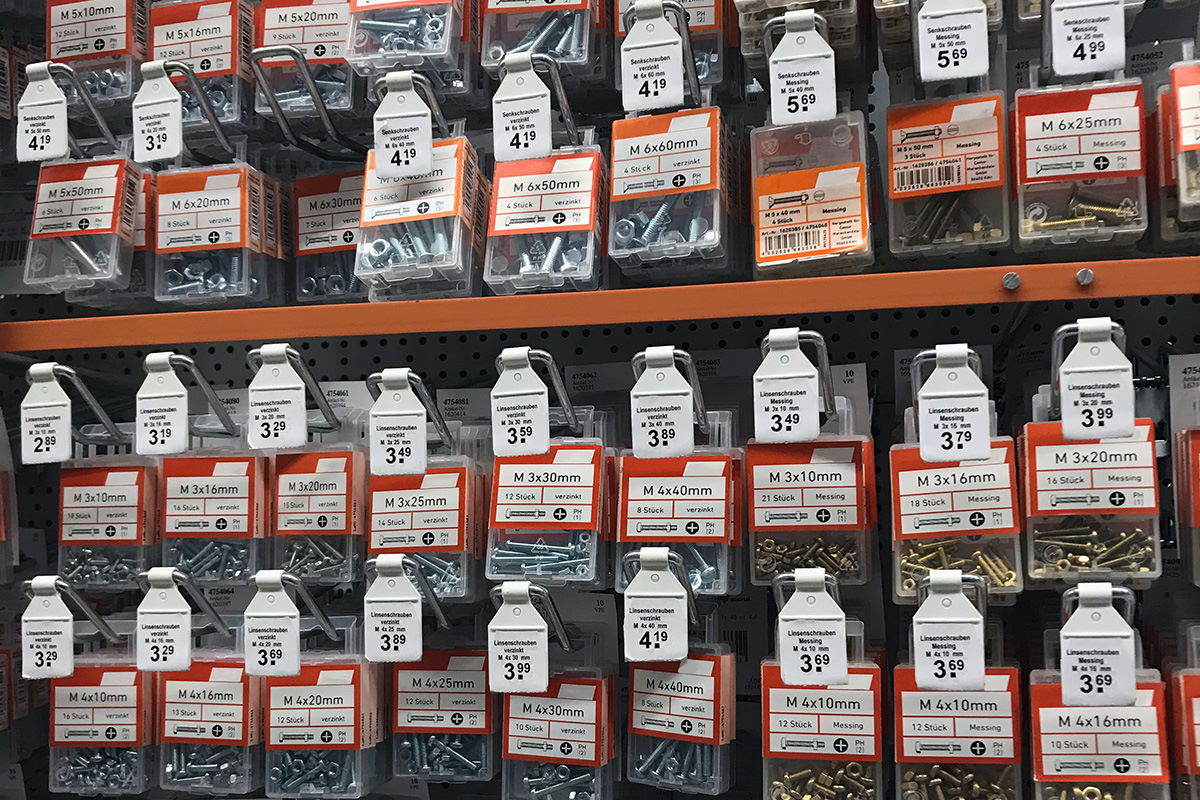 Solutions for the construction materials sector: Hook with label flag in the hardware store, shelf view.