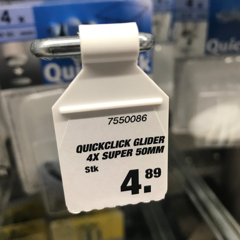Solutions for the construction materials sector: Hook with label flag in the hardware store, front side.