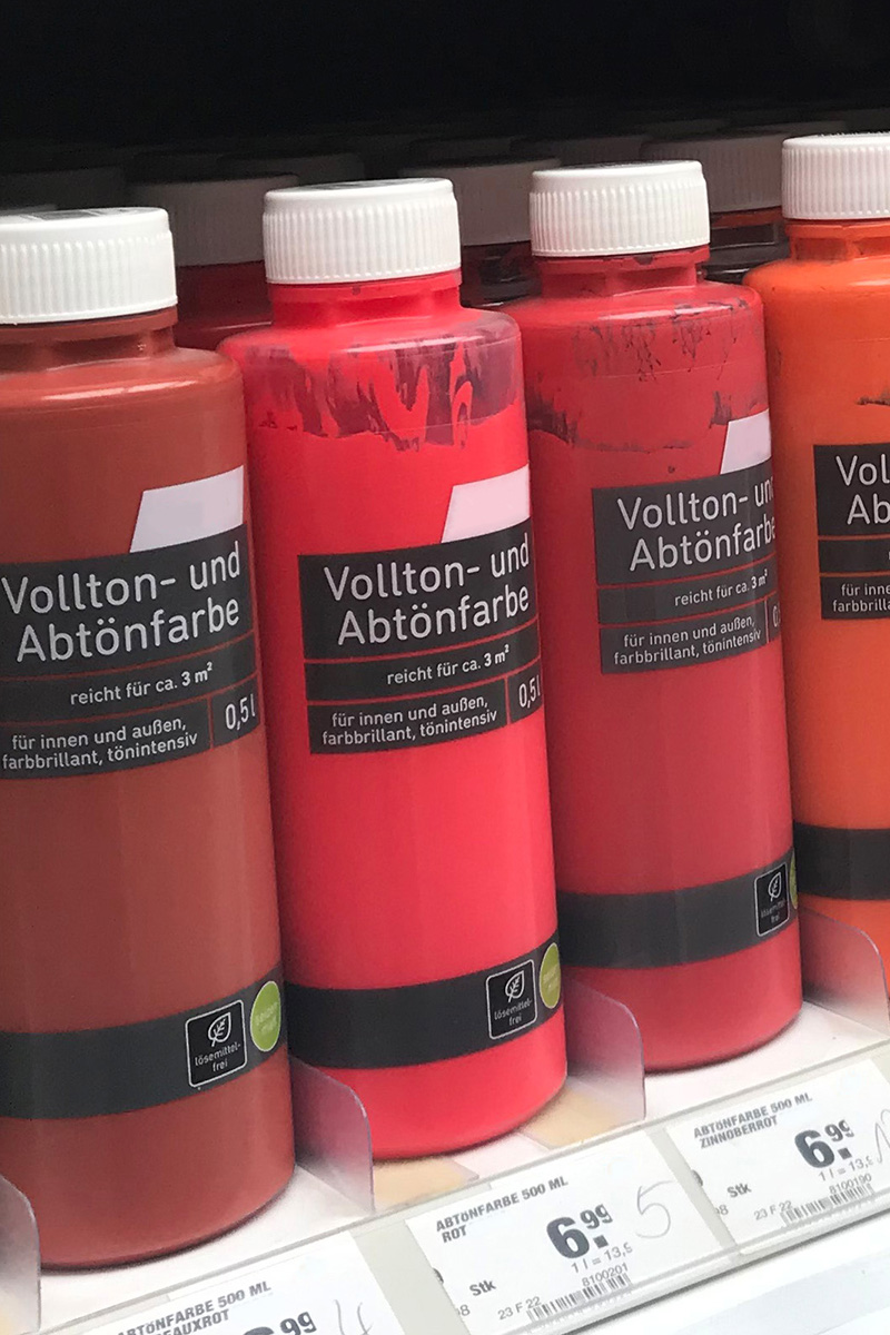 Solutions for the construction materials sector: Digital printed labels on color bottles in the hardware store shelf, front detail.