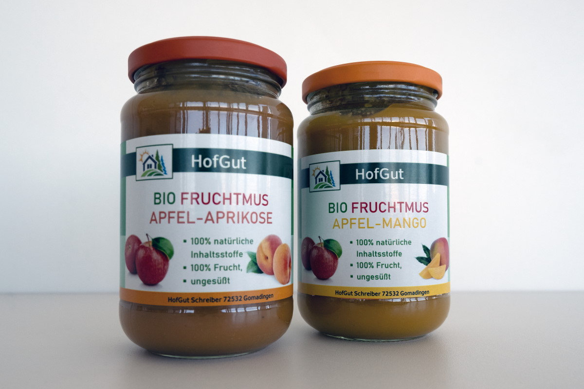 Order roll labels online in digital printing: glass labels for organic fruit puree, 2 jars, light background.
