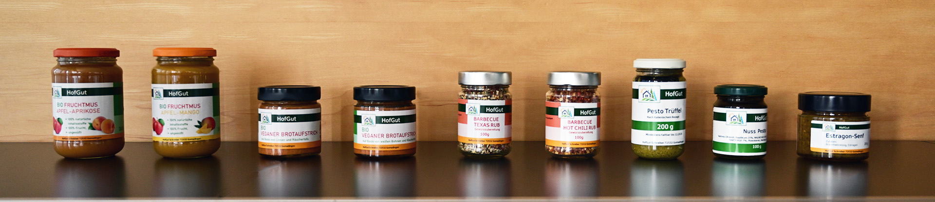 Order roll labels online in digital printing: 9 different products in glass, with glass labels, wooden background.