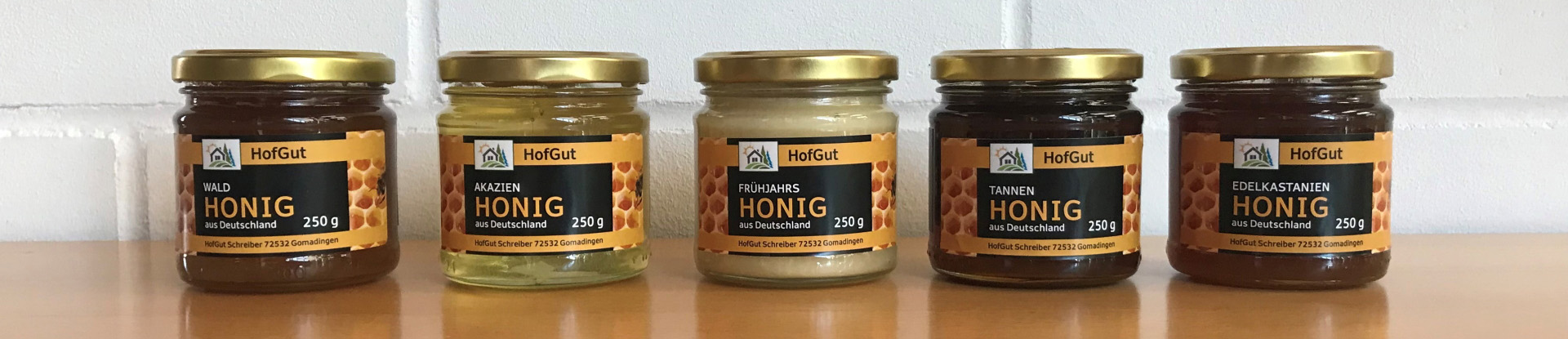 Order roll labels online in digital printing: 5 different honey labels on a light background, landscape format.