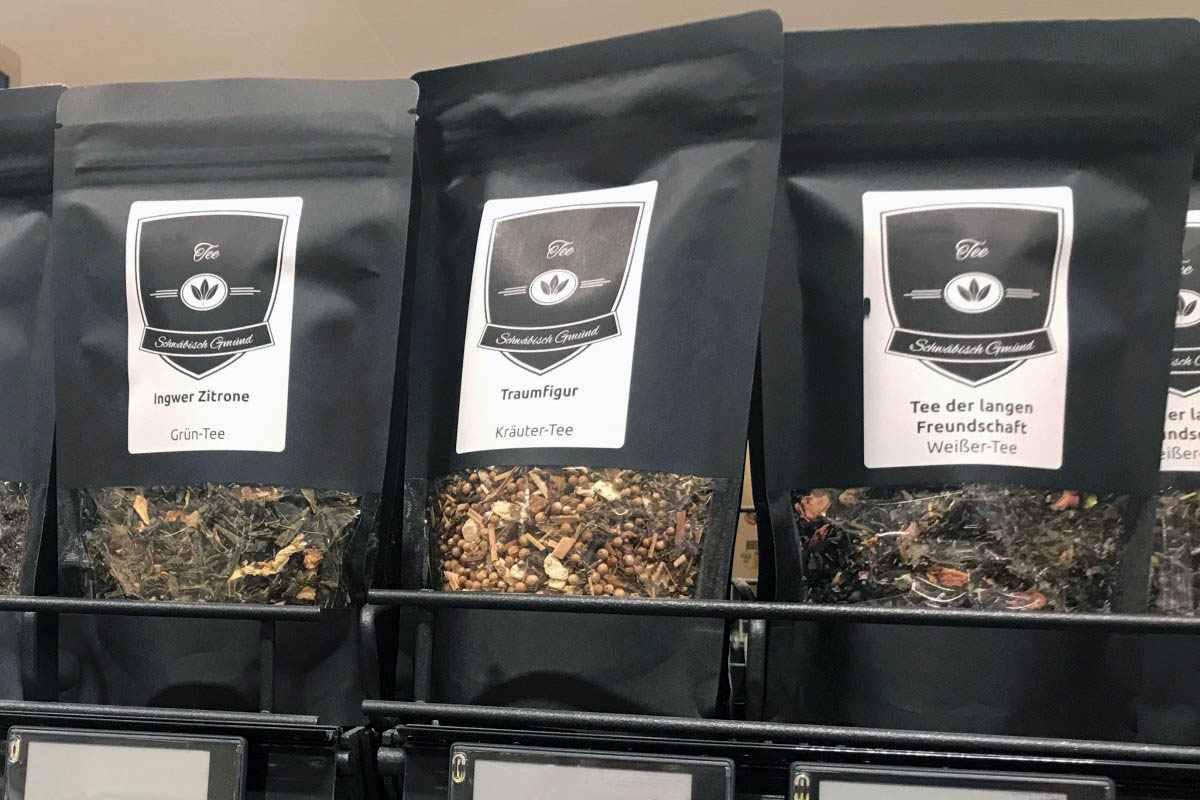 Order roll labels online in digital printing: Tea labels on black packaging on the shelf.