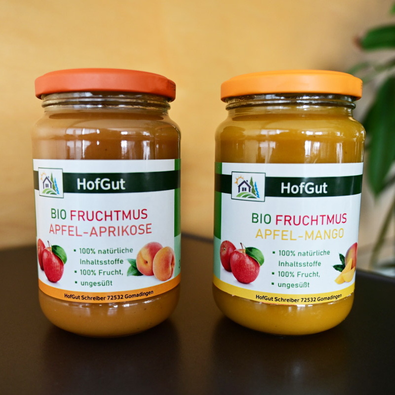 Order roll labels online in digital printing: glass labels for organic fruit puree, 2 jars, wooden background.