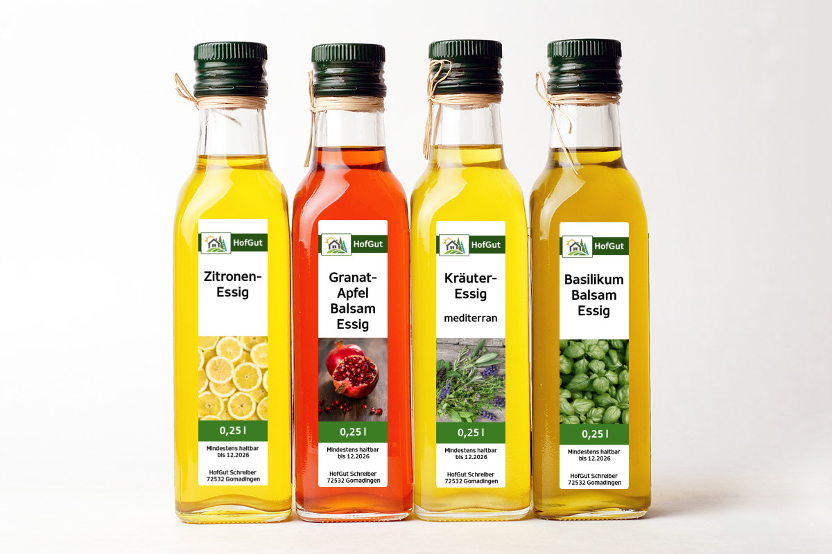 Order roll labels online in digital printing: 4 bottles with vinegar labels, light background.