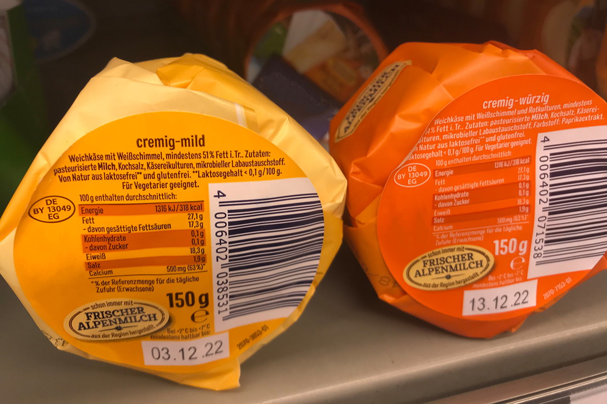 Food Solutions: Two-in-one product and closure label, pre-printed in color, later printed with thermal transfer including content, MHC, barcode, on cheese packaging.