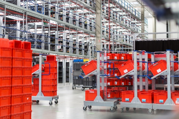 Small parts storage with labels on red transport boxes.