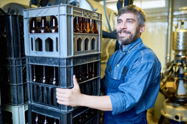 Employees with beverage crates in the beverage industry.