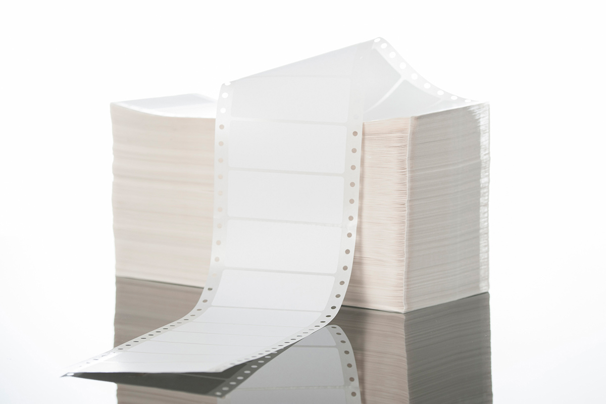 Blank labels: Stack of HERMA folded labels, also known as computer labels or perforated edge labels.