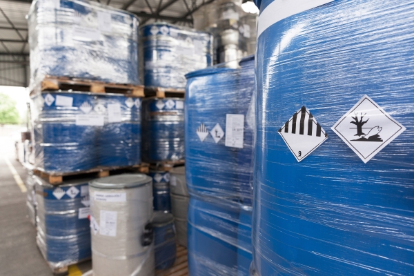 Hazardous substance and hazardous goods labels: Hazardous goods labels on shrink-wrapped containers in the chemical industry.