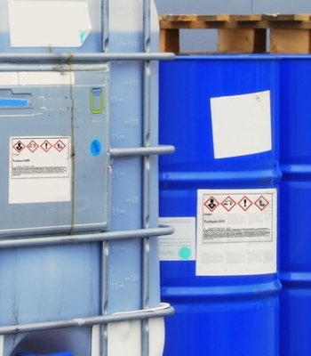 Hazardous Substance and Dangerous Goods Labels: Hazardous substance labels on chemical containers in outdoor areas
