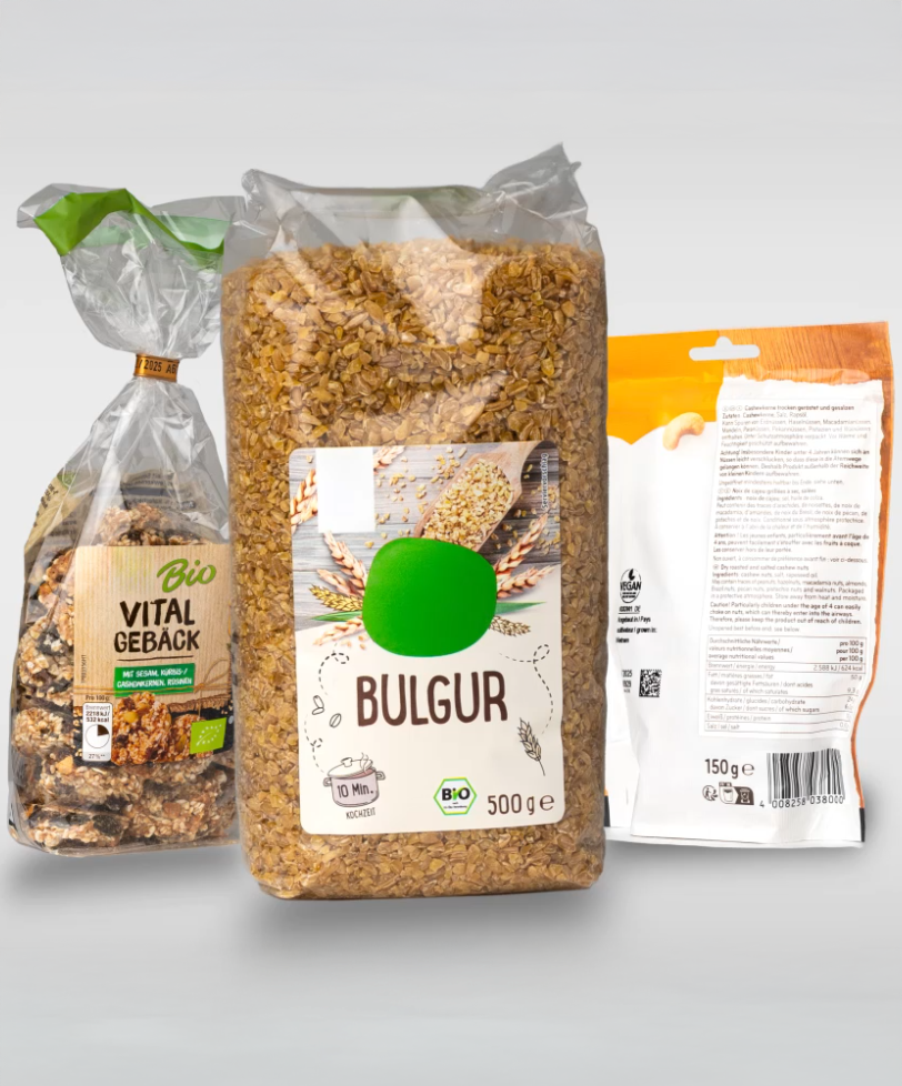Three packages of food: one with bulgur, one with healthy snacks, and another with unreadable text on the back.