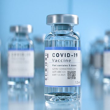 COVID-19 vaccine vial with a label indicating it contains 5 doses. Visible information on GTIN, lot number, and expiration date.