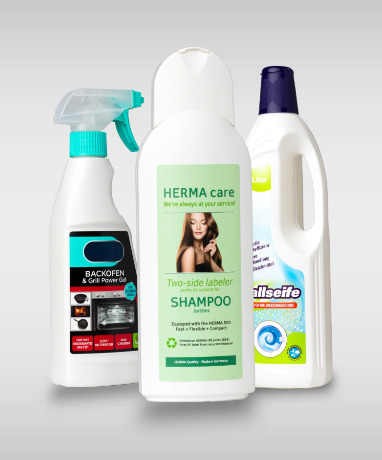 Three cleaning products: an oven spray, a shampoo bottle with dual labeling, and a bottle cleaner.