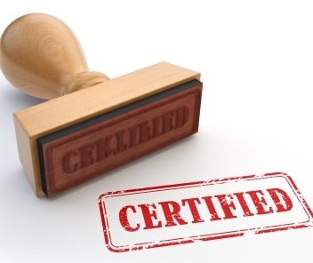 A wooden stamp with the inscription 'CERTIFIED' in red, next to a red stamp impression of the word 'CERTIFIED'.