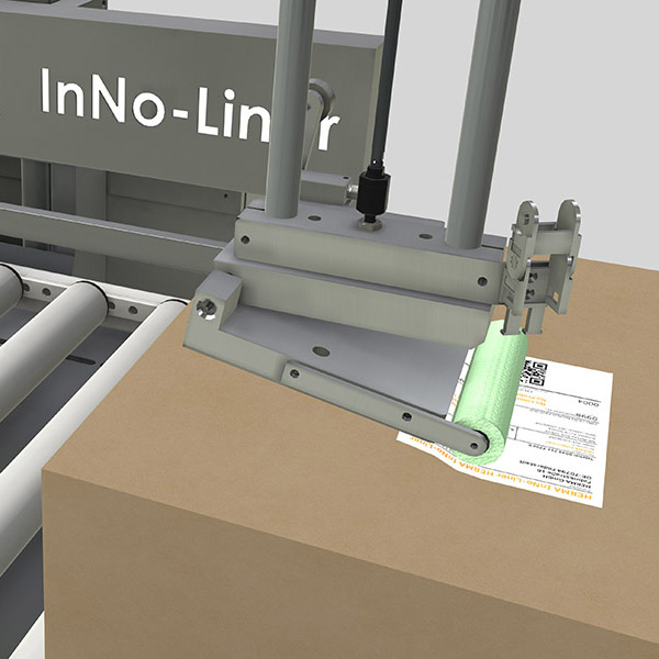 Machine with an attachment for processing materials, labeled 'InNo-Liner,' next to a stack of paper documents.