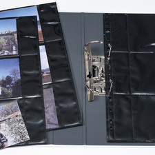 Ein offenes Fotoalbum mit mehreren Seiten, die Landschafts- und Architekturaufnahmen zeigen, sowie einer einzelnen Fotokarte.