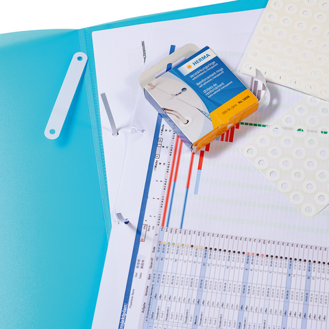 A blue binder with a diagram, a box of adhesive labels, and a sheet of notes.