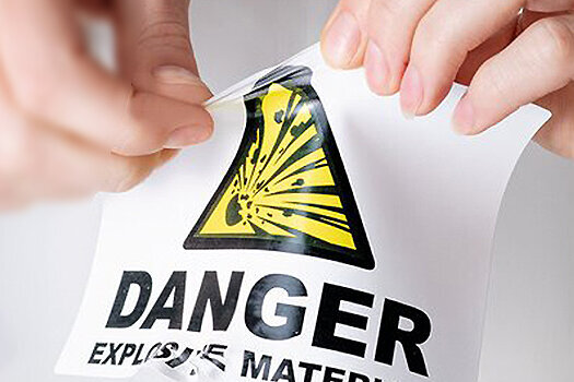Foil label with a hand trying to tear the label apart.