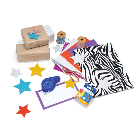 Gift wrap, colorful papers, scissors, glue, and decorative elements like stars in various colors on a table.