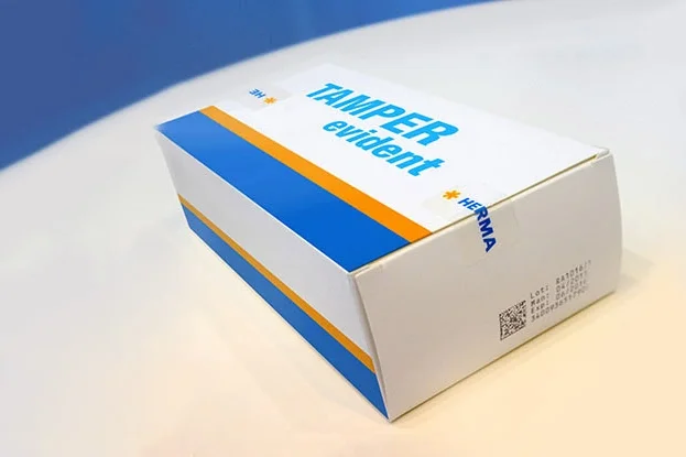 Tamper Evident Label on HERMA packaging, original seal, landscape format.
