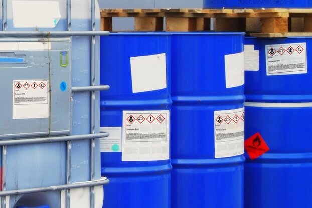 HERMA hazardous material labels on blue steel drums and big bags, landscape format