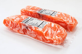 Packaged salmon fillets in clear plastic, with nutritional information on the label.
