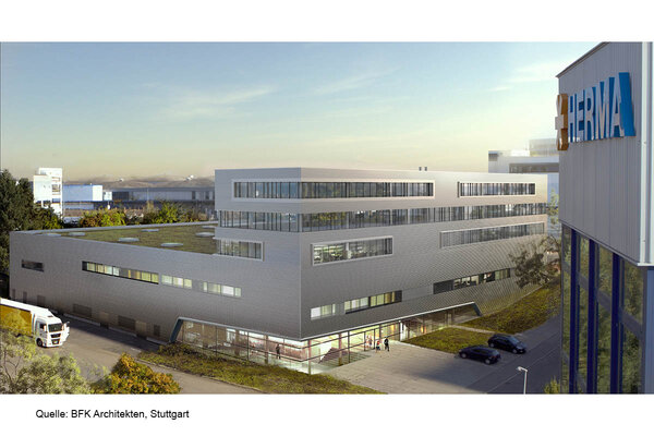 Modern office buildings with large windows and a curved facade, surrounded by green spaces and parking lots.