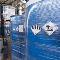 Hazardous Material and Dangerous Goods Labels: Dangerous goods labels on shrink-wrapped containers in the chemical industry.