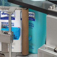 Mineral shower gel bottles on a shelf, with a blue label and a gray holder.