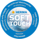 Runder Aufkleber mit dem Text "HERMA SOFT TOUCH", der Eigenschaften wie "sensationell weiche Haptik" und "super elastisch" hervorhebt.