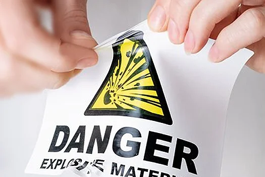 Foil label with a hand trying to tear the label apart.