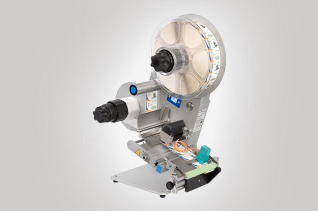 An industrial labeling machine with a large roller mechanism and multiple controls for customization.