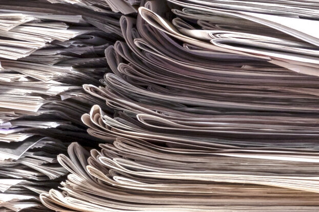 Scrap paper in a stack, basic material for HERMA recycling labels, landscape format.