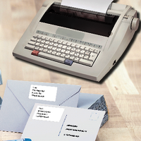 Envelopes with address labels and a typewriter